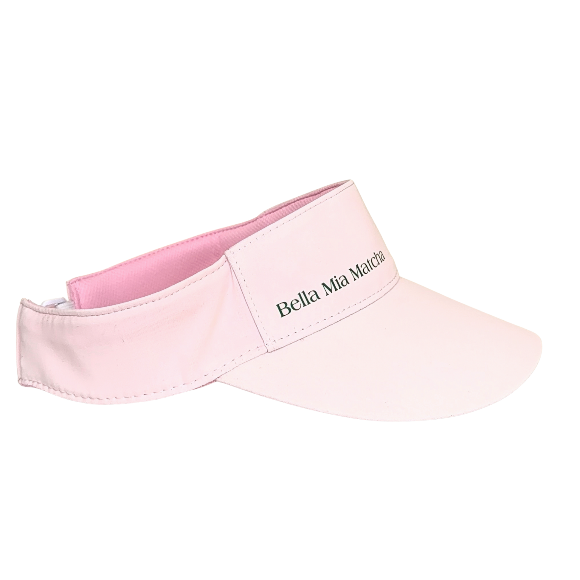 A light pink visor hat with a darker pink inner lining and green embroidered text reading Bella Mia Matcha on the front strap